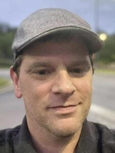 Close up image of a man wearing a cap