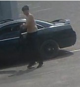 topless man getting into a car