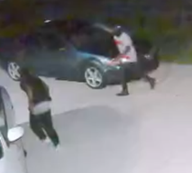 men sneaking around a car
