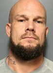 bearded man with a neck tattoo